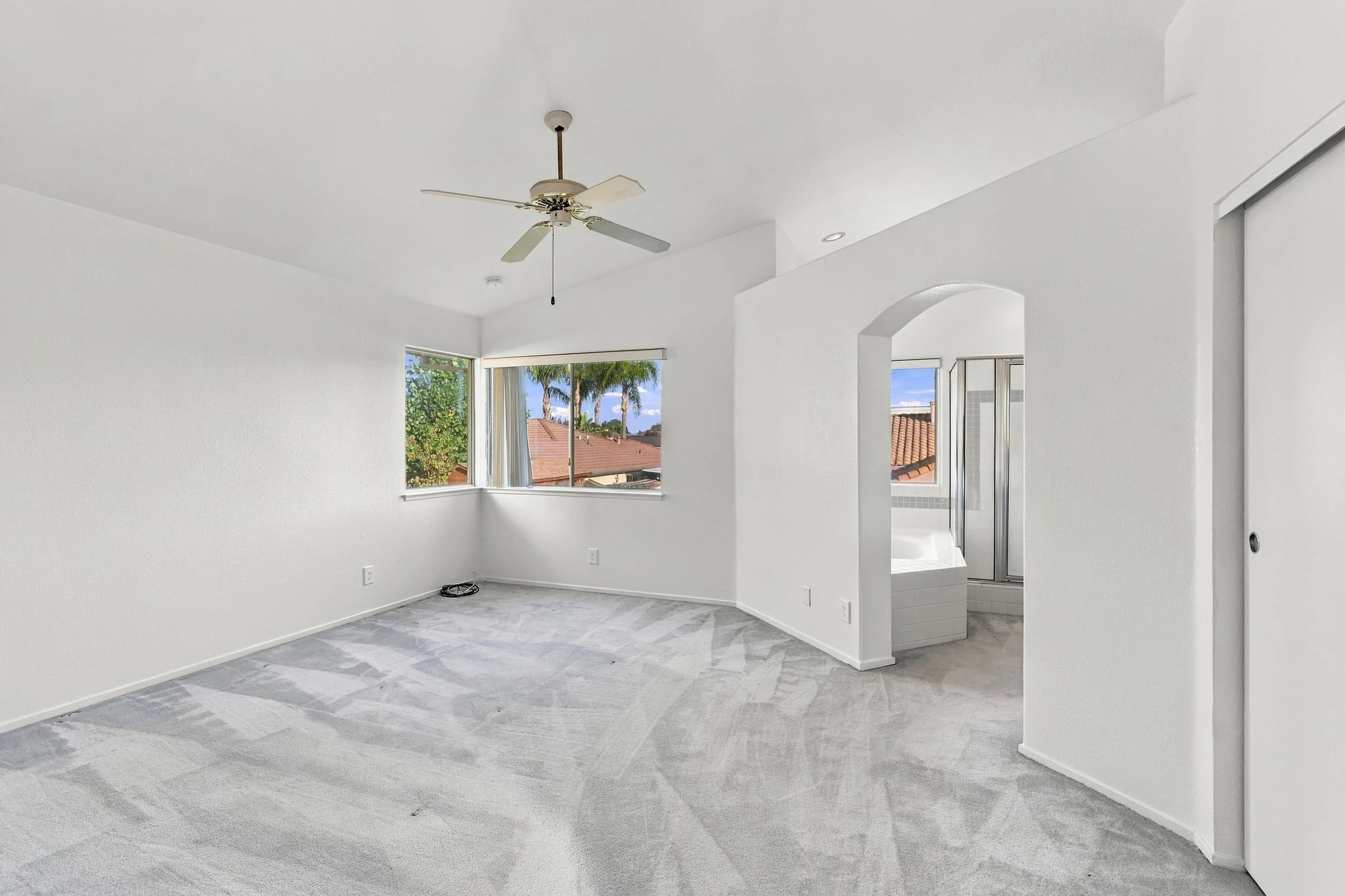 Primary bedroom and adjoining bathroom entry